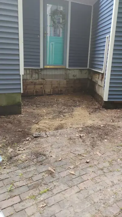 Doorway with the old wooden steps gone and the ground cleared